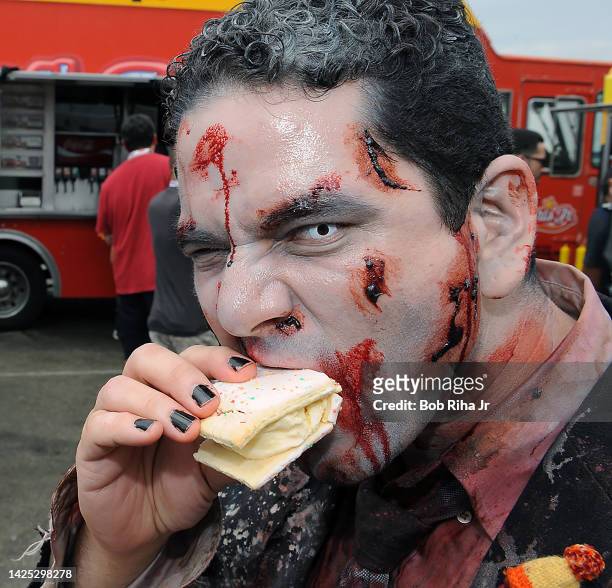 Comic-Con and zombie fan Dwight Bragdon of San Diego, devours a Strawberry Pop-Tart Ice Cream Sandwich outside Comic-Con, July 20, 2013 in San Diego,...