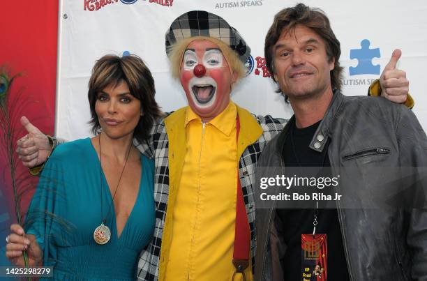 Actors Lisa Rhinna and her husband Harry Hamlin with 'Jeff Taub, aka 'Baco', as they arrive to the opening night performance of Ringling Bros. Show...