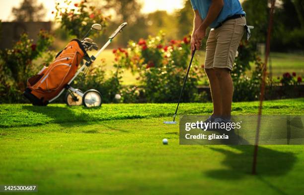 young man at a golf course. - golf clubhouse stockfoto's en -beelden