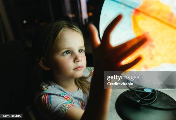 little girl with a globe - child globe stock pictures, royalty-free photos & images