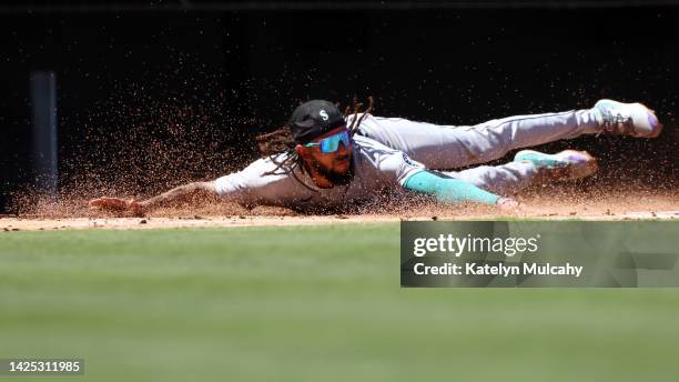 Crawford of the Seattle Mariners slides into home plate during the first inning against the Los Angeles Angels at Angel Stadium of Anaheim on...