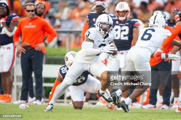 Wide receiver Parker Washington of the Penn State Nittany Lions runs the ball by safety Cayden Bridges of the Auburn Tigers at Jordan-Hare Stadium on...