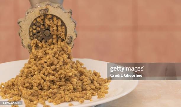 Chopped walnut kernels through a mincer close up - Recipe concept. chopped walnut kernels through mincer close