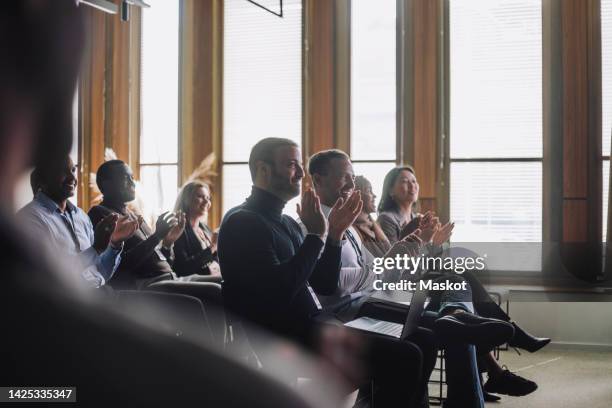 smiling multiracial business colleagues applauding in meeting during panel discussion - panelist stock pictures, royalty-free photos & images