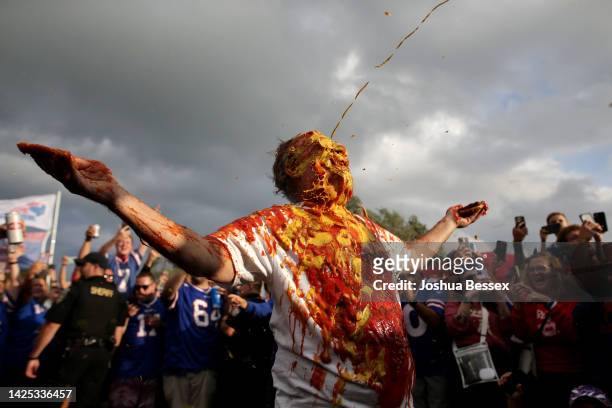 Buffalo Bills fan is covered in Mustard and Ketchup prior to the game between the Tennessee Titans and the Buffalo Bills at Highmark Stadium on...