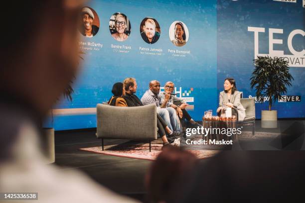 multiracial tech entrepreneurs discussing during panel at conference event - african american interview stock pictures, royalty-free photos & images