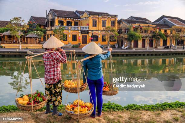 vietnamese women selling tropical fruits, old town in hoi an city, vietnam - vietnam stock pictures, royalty-free photos & images