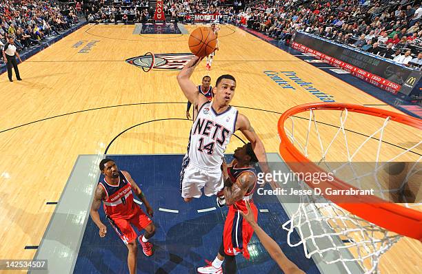 Gerald Green of the New Jersey Nets dunks over Roger Mason Jr. #8 of the Washington Wizards on April 6, 2012 at the Prudential Center in Newark, New...