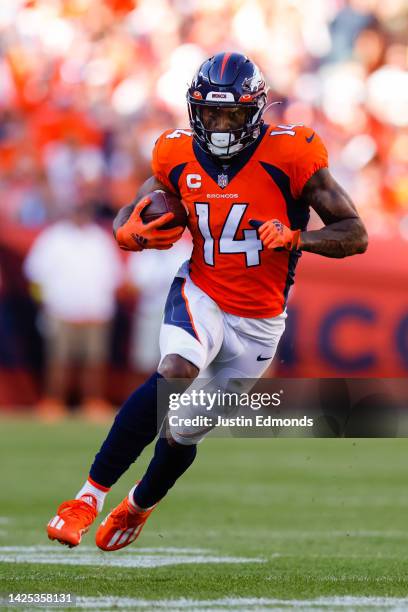 Wide receiver Courtland Sutton of the Denver Broncos runs with the football after catching a pass during the fourth quarter against the Houston...