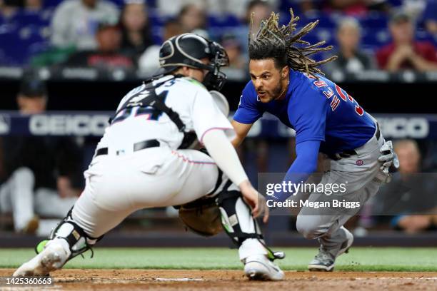 Michael Hermosillo of the Chicago Cubs dives for home during the fifth inning against the Miami Marlins at loanDepot park on September 19, 2022 in...