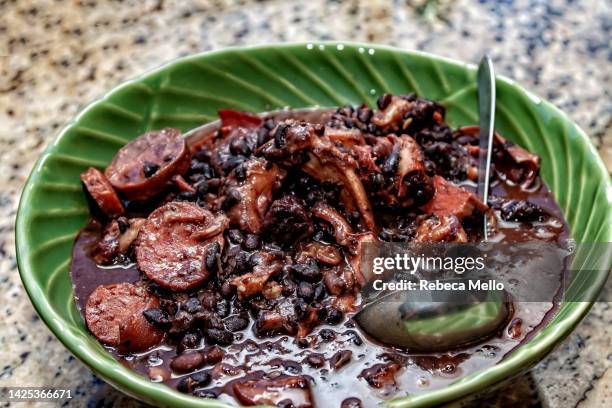 brazilian feijoada, beans and pork, is served ready to eat. - brazilian feijoada dish stock-fotos und bilder