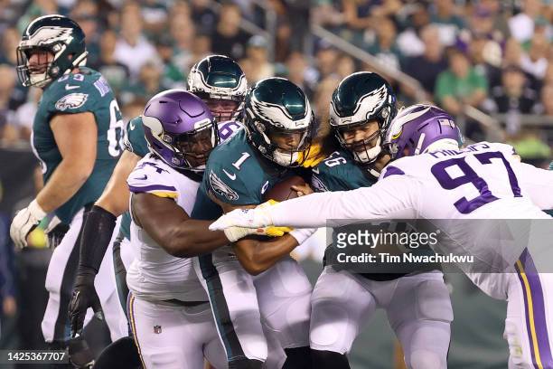 Dalvin Tomlinson of the Minnesota Vikings tackles Jalen Hurts of the Philadelphia Eagles during the first quarter at Lincoln Financial Field on...