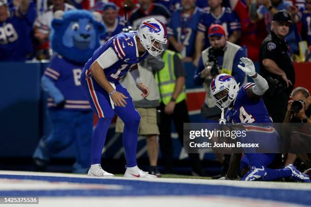 Stefon Diggs of the Buffalo Bills celebrates with teammate Josh Allen after scoring a touchdown against the Tennessee Titans during the third quarter...