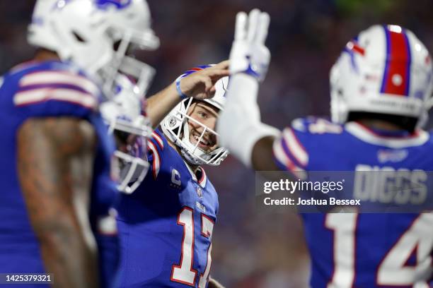 Stefon Diggs of the Buffalo Bills celebrates with Josh Allen after scoring his third touchdown of the night against the Tennessee Titans during the...