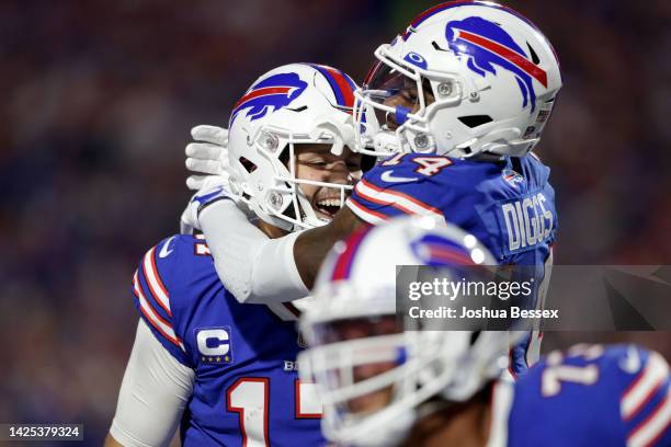 Stefon Diggs of the Buffalo Bills celebrates with Josh Allen after scoring his third touchdown of the night against the Tennessee Titans during the...