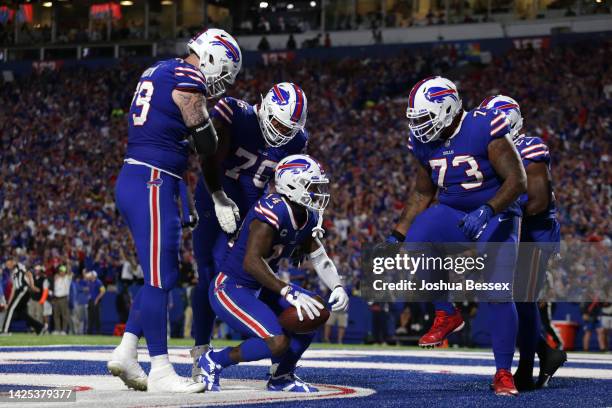 Stefon Diggs of the Buffalo Bills celebrates with his teammates after scoring his third touchdown of the night against the Tennessee Titans during...