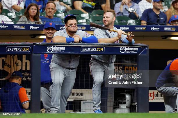 Pete Alonso and Daniel Vogelbach of the New York Mets share a laugh on the top step of dugout in the seventh inning against the Milwaukee Brewers at...