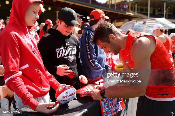 Josh P. Kennedy signs autographs with Swans supporters after a Sydney Swans AFL training session at Sydney Cricket Ground on September 20, 2022 in...