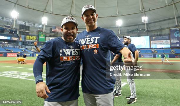 Jose Altuve and Mauricio Dubon of the Houston Astros celebrates winning the American League West Division following a game against the Tampa Bay Rays...