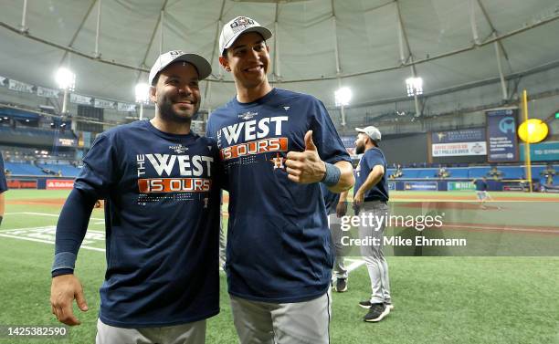 Jose Altuve and Mauricio Dubon of the Houston Astros celebrates winning the American League West Division following a game against the Tampa Bay Rays...