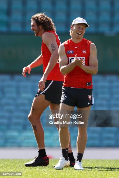 Tom Hickey and Callum Mills laugh during a Sydney Swans AFL training session at Sydney Cricket Ground on September 20, 2022 in Sydney, Australia.