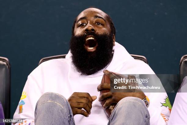 James Harden of the Philadelphia 76ers reacts with a game ball during the third quarter between the Philadelphia Eagles and the Minnesota Vikings at...
