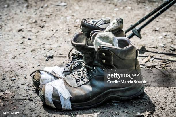 worn and taped hiking boots - broken heel stock-fotos und bilder