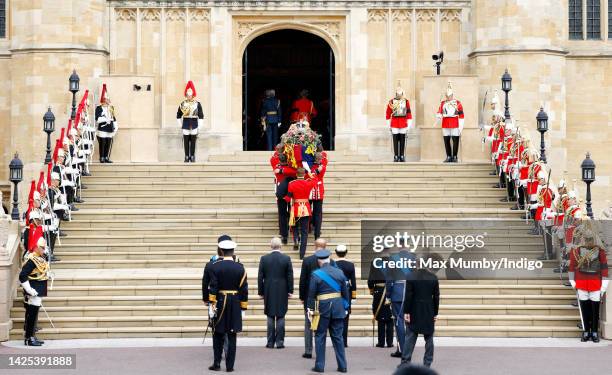 Pallbearers from Queen's Company, 1st Battalion Grenadier Guards carry Queen Elizabeth II's coffin, draped in the Royal Standard, into St George's...