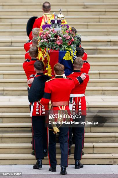 Pallbearers from Queen's Company, 1st Battalion Grenadier Guards carry Queen Elizabeth II's coffin, draped in the Royal Standard, into St George's...