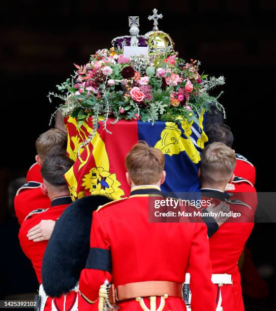 Pallbearers from Queen's Company, 1st Battalion Grenadier Guards carry Queen Elizabeth II's coffin, draped in the Royal Standard, into St George's...