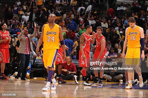 Courtney Lee and Chandler Parsons of the Houston Rockets come together while Kobe Bryant and Pau Gasol of the Los Angeles Lakers look on dejectedly...