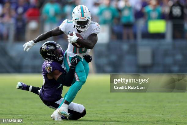 Safety Chuck Clark of the Baltimore Ravens tackles wide receiver Tyreek Hill of the Miami Dolphins after catching a second half pass at M&T Bank...