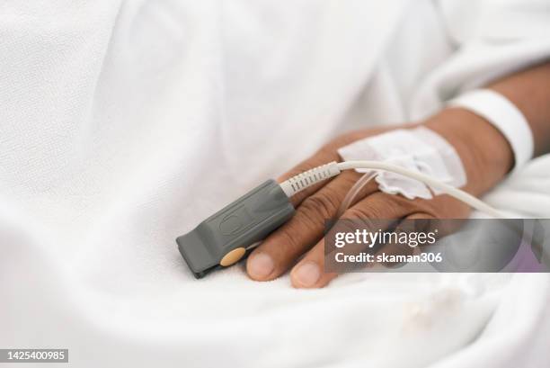 close up a finger of the patient checking the pulse oximeter for the monitor pulse - people with both male and female organs bildbanksfoton och bilder