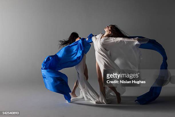 two woman draped in silk - flowing silk stock-fotos und bilder