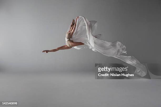 ballerina performing a grand jeté - white silk stock pictures, royalty-free photos & images
