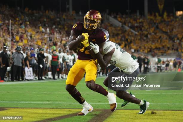 Wide receiver Andre Johnson of the Arizona State Sun Devils catches a three-yard touchdown reception ahead of defensive back Kempton Shine of the...