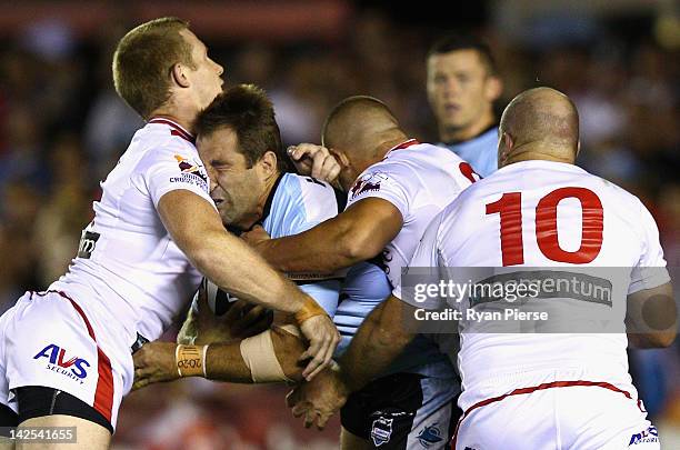 Ben Ross of the Sharks is tackled by Ben Creagh of the Dragons during the round six NRL match between the Cronulla Sharks and the St George Illawara...