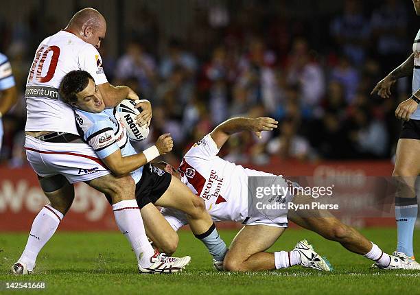 Nathan Gardner of the Sharks is tackled by Michael Weyman of the Dragons during the round six NRL match between the Cronulla Sharks and the St George...