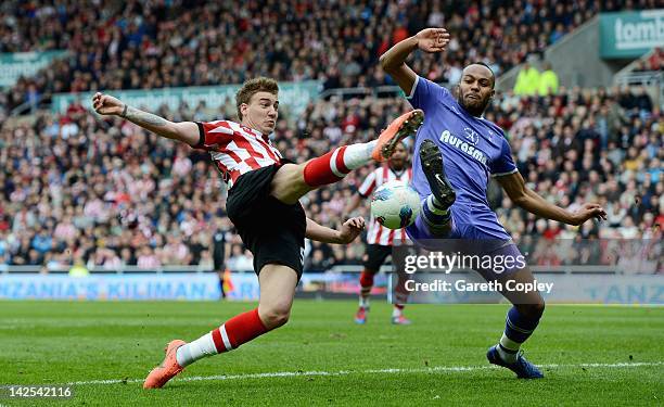 Nicklas Bendtner of Sunderland is challenged by Younes Kaboul of Tottenham during the Barclays Premier League match between Sunderland and Tottenham...