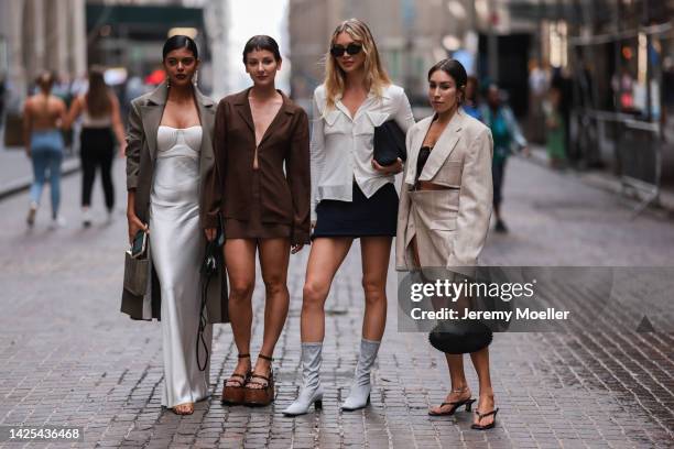 Alyssa Coscarelli, Jessie Andrews, Lauren Caruso seen wearing a white long dress, brown suit, black skirt and bag and sunglasses, beige boots, a...