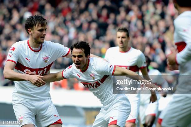 Tamas Hajnal of Stuttgart celebrates with teammate William Kvist after scoring his team's first goal during the Bundesliga match between VfB...