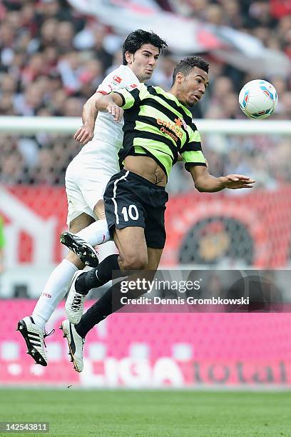 Serdar Tasci of Stuttgart and Eric Maxim Choupo-Moting of Mainz jump for a header during the Bundesliga match between VfB Stuttgart and FSV Mainz 05...