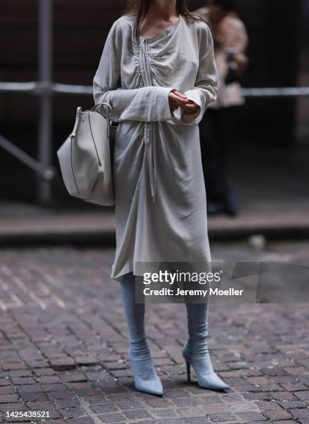 Fashion Week Guest seen wearing a white dress, babyblue overknees heels, beige handbag and sunglasses outside Bevza, during New Yorker Fashion Week...