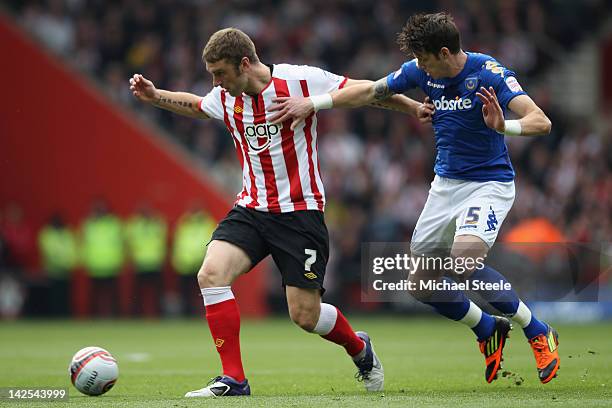 Rickie Lambert of Southampton holds off Jason Pearce of Portsmouth during the npower Championship match between Southampton and Portsmouth at St...