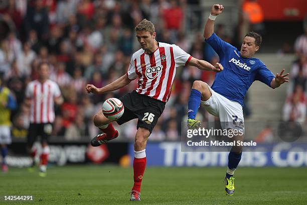 Jos Hooiveld of Southampton challenged by Chris Maguire of Portsmouth during the npower Championship match between Southampton and Portsmouth at St...
