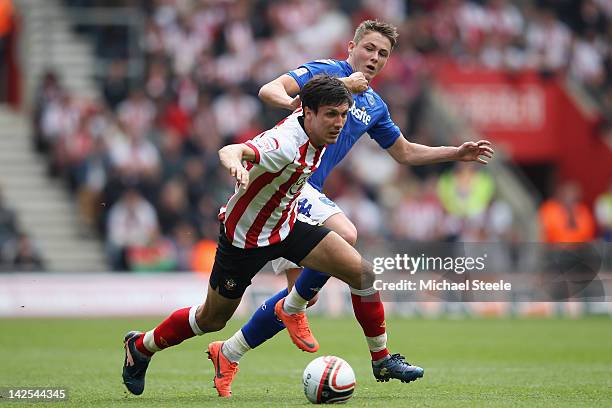 Jack Cork of Southampton is challenged by Scott Allan of Portsmouth during the npower Championship match between Southampton and Portsmouth at St...