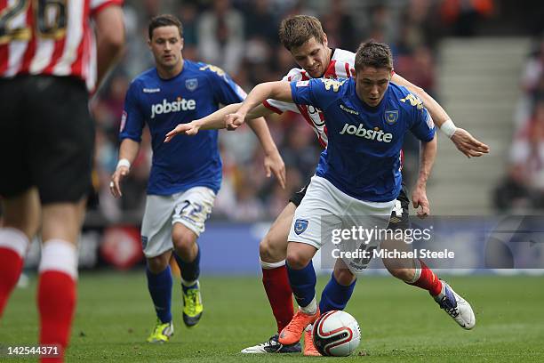 Scott Allan of Portsmouth is shadowed by Dean Hammond of Southampton during the npower Championship match between Southampton and Portsmouth at St...