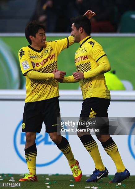 Ilkay Guendogan of Dortmund celebrates with his team mate Shinji Kagawa after scoring his team's second goal during the Bundesliga match between VfL...
