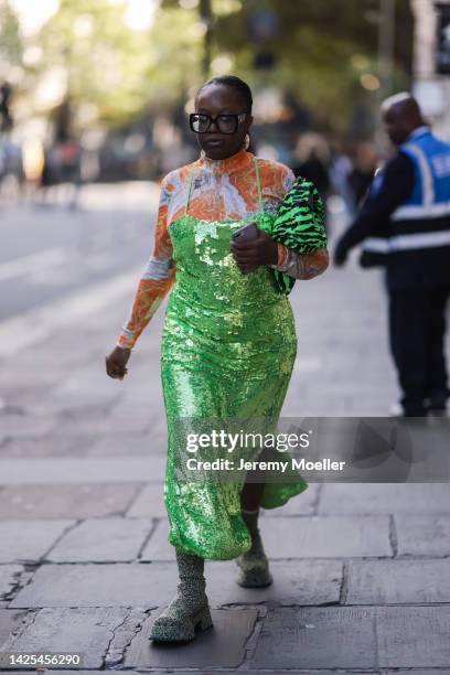 Fashion week guest seen wearing a green sequins dress, outside poster girl during London Fashion Week September 2022 on September 16, 2022 in London,...