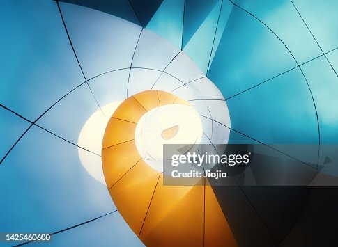 Spiral staircase illuminated by neon light at night Spiral staircase illuminated by neon light at night